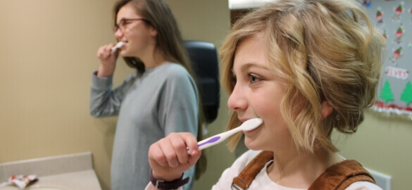 girls brushing teeth
