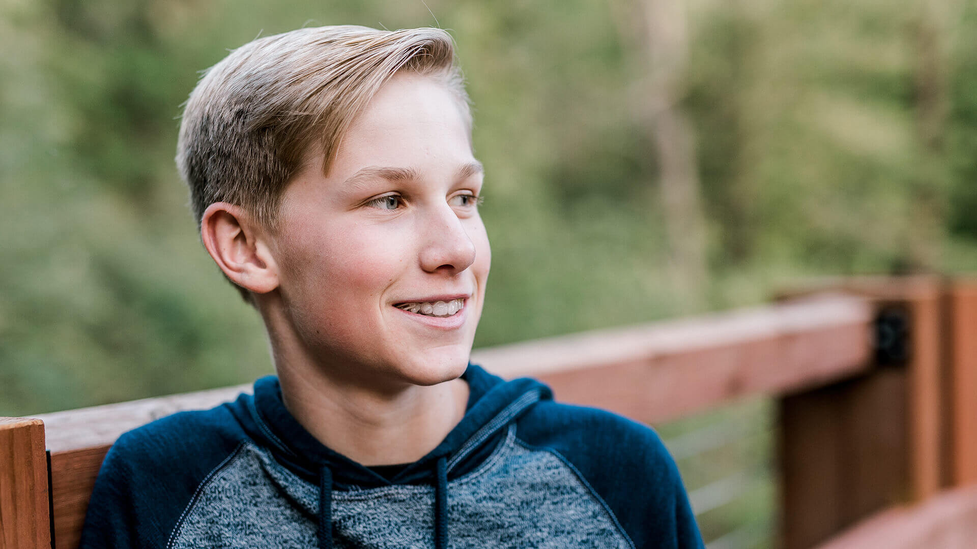 boy smiling with an invisalign aligner