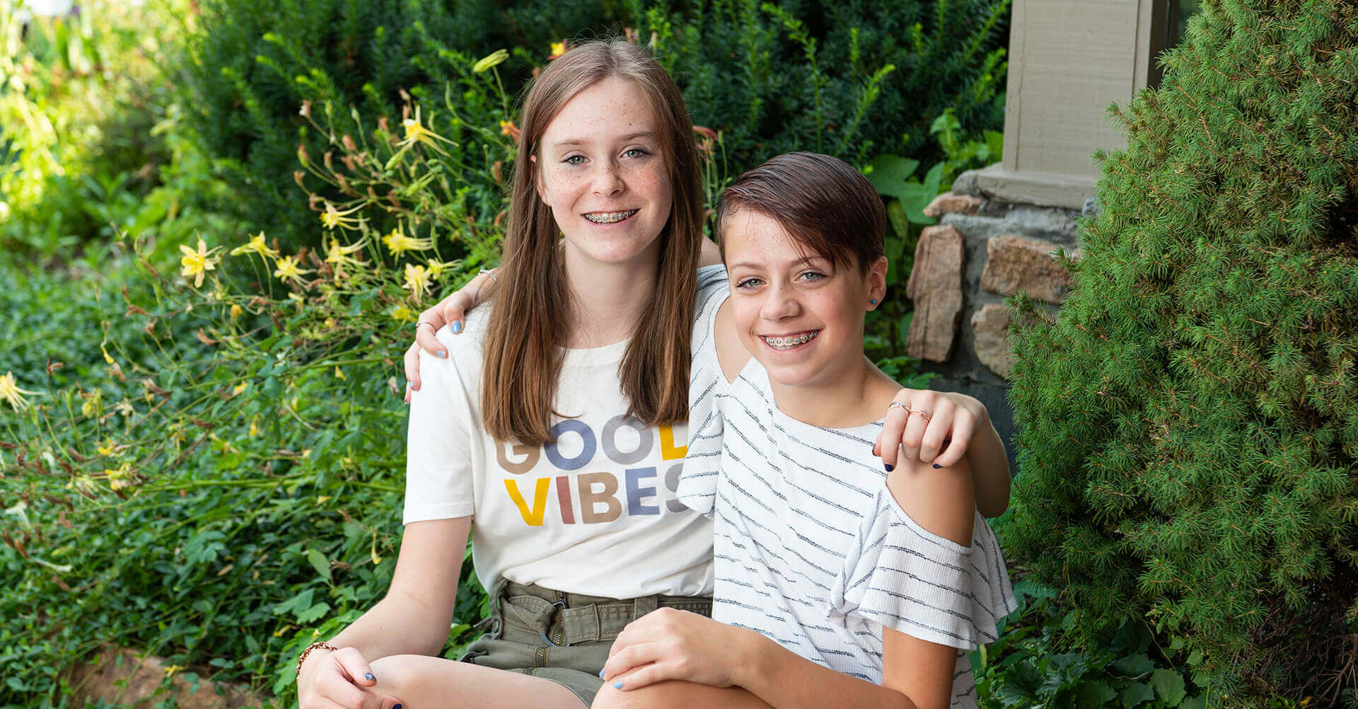 smiling siblings with braces